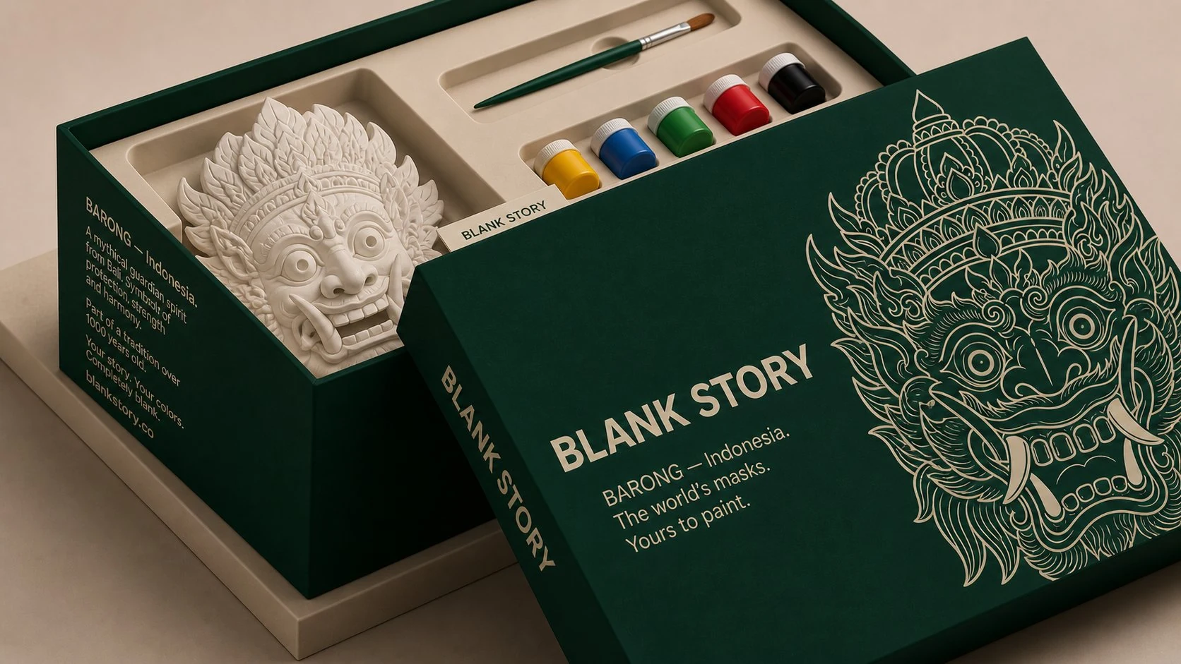 Barong BLANK Story mask painting kit, forest-green box open showing white plaster Balinese guardian mask, paint pots, and brush