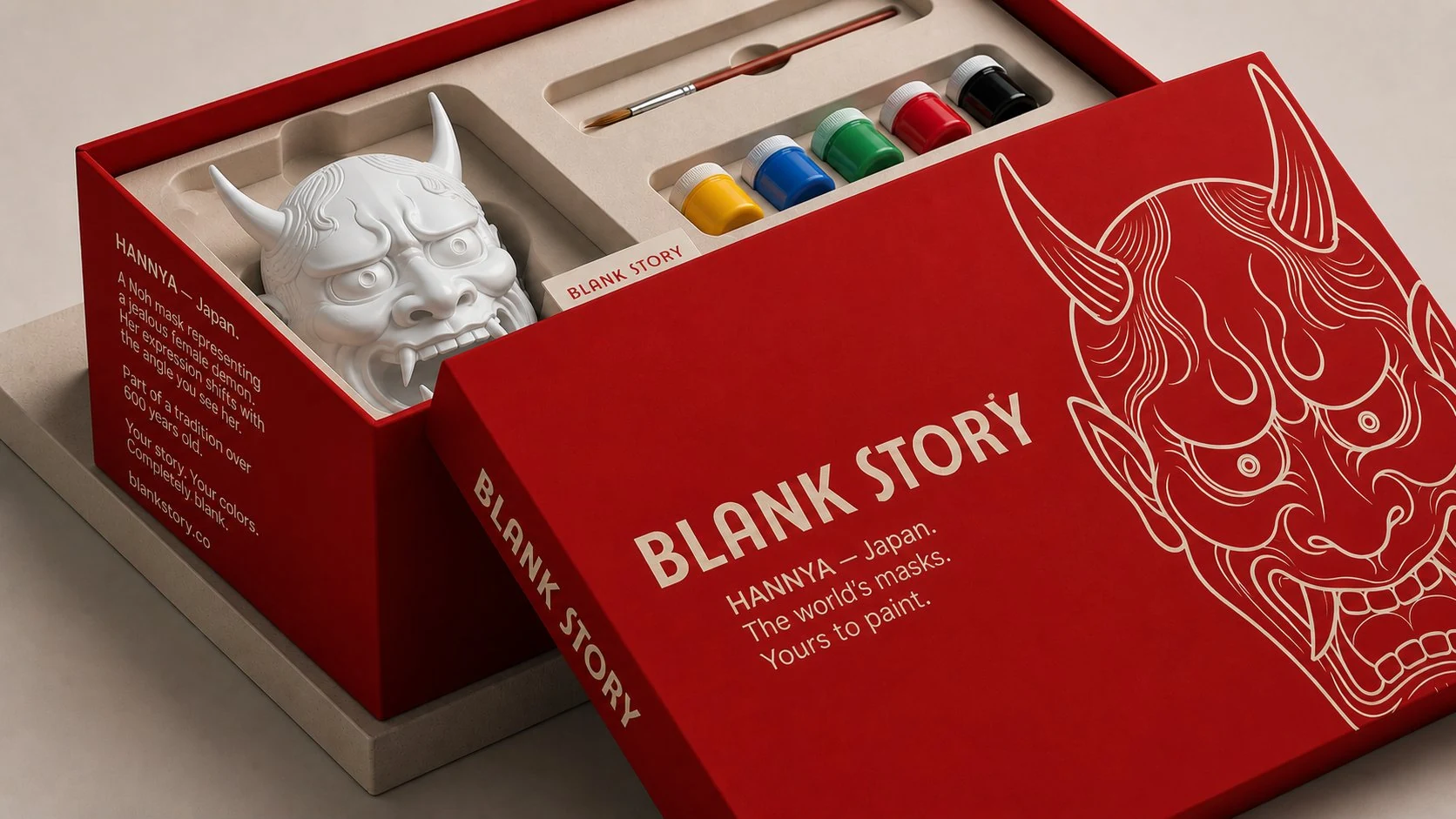 Hannya BLANK Story mask painting kit, red box open showing white plaster demon mask, five paint pots, and one brush