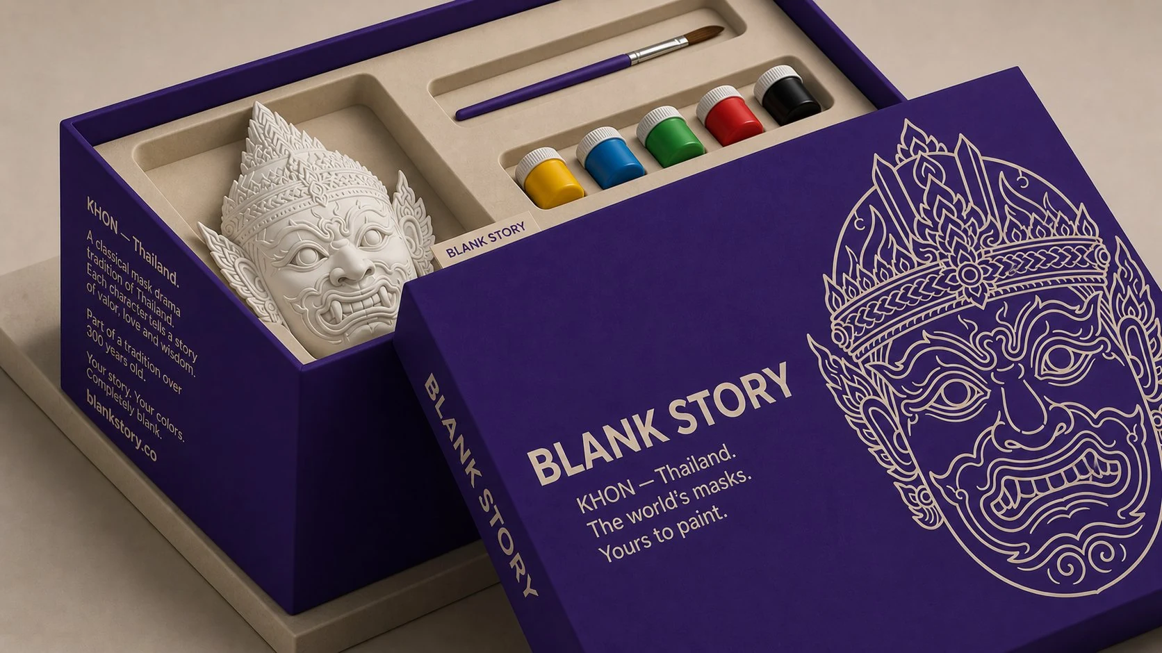 Khon BLANK Story mask painting kit, deep-purple box open showing white plaster Thai demon mask, paint pots, and brush